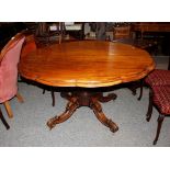 A 19th Century walnut shaped top dining table, raised on a  bulbous turned central column and carved