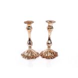 A pair of plate on copper Rococo style candlesticks, with foliate decoration, 24cm high