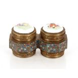 A pair of unusual Chinese cloisonné decorated octagonal pots, with porcelain lids, decorated