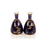 A pair of Royal Crown Derby vases, with gilt foliate trailing decoration on a rich blue ground, 17cm