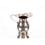 A small George V silver baluster cream jug, of pla