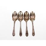 A set of four George V silver teaspoons, with crossed golf clubs motif by Walker & Hall, Sheffield