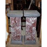 A pair of marble and black slate columns, having square tops raised on stepped bases, 90cm high, the