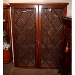 A large oak bookcase, enclosed by glazed astragal doors, 150cm wide x 195cm high