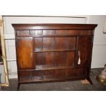 An antique oak dresser rack, shelved and boarded, flanked by cupboards,160cm wide x 123cm high