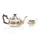 A silver teapot, by The Goldsmiths and Silversmiths Co. London 1913, with black wood handle and