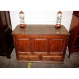 An 18th Century oak mule chest, the hinged above three fielded panels,two drawers to the base, 121cm