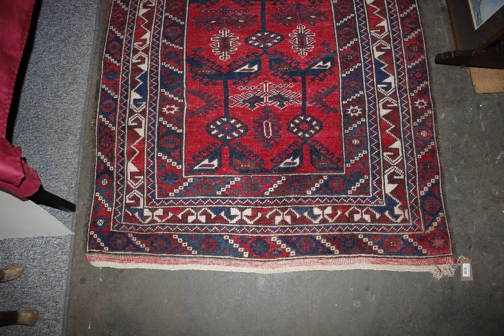 A Middle Eastern wool rug, of Caucasian design having stylised motifs on a brick red ground, 186cm x - Image 3 of 5