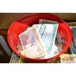 A tub of various bank notes and world coinage