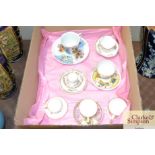 A box containing seven miniature cups and saucers