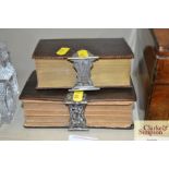 Two white metal clasped Bibles