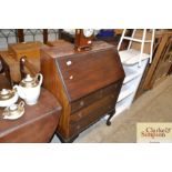 A mahogany bureau fitted three drawers raised on c