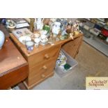 A pine knee hole dressing table fitted three drawe