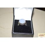 A boxed silver and moonstone set ring