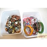 Two tubs of various costume jewellery