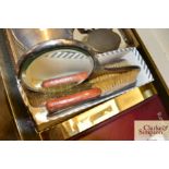 A box containing silver backed dressing table item