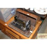 A Frister & Rossman hand sewing machine in fitted