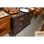 An antique carved mahogany chest of two short over two long drawers