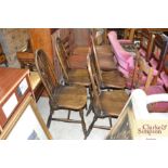 A set of four Ercol style stick back chairs