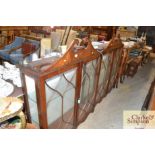 A pair of astragal glazed hanging cabinets with gl