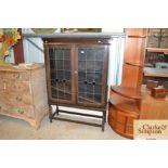 A 1930's oak and leaded glazed bookcase on barley