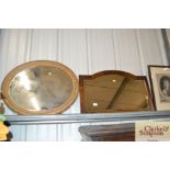 A 1930's oak framed bevel edged wall mirror and an