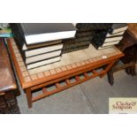 A teak and tile topped coffee table