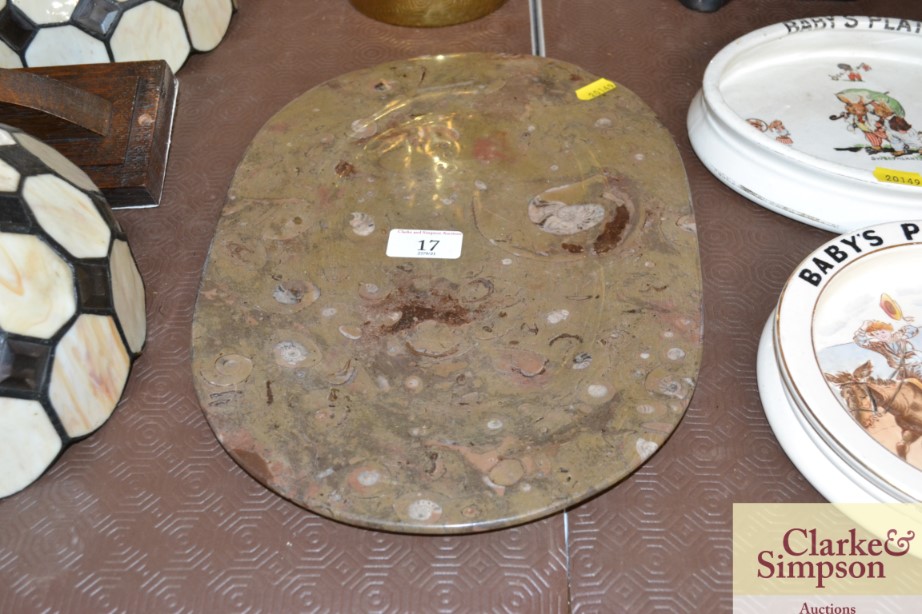 A stone dish with encrusted fossils