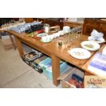 A good quality light oak extending dining table