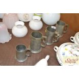 Four pewter tankards