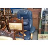 A blue upholstered swivel chair and matching foots