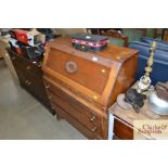 A bureau fitted three long drawers