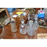 A quantity of various decanters and stoppers; a so