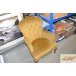 A buttoned nursing chair in old gold Dralon