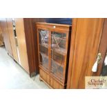 A reproduction yew wood bookcase