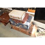 Three suitcases and a travelling trunk