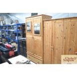 A stripped pine double hanging wardrobe fitted wit
