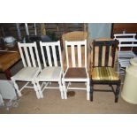 Three white painted chairs and a black painted cha