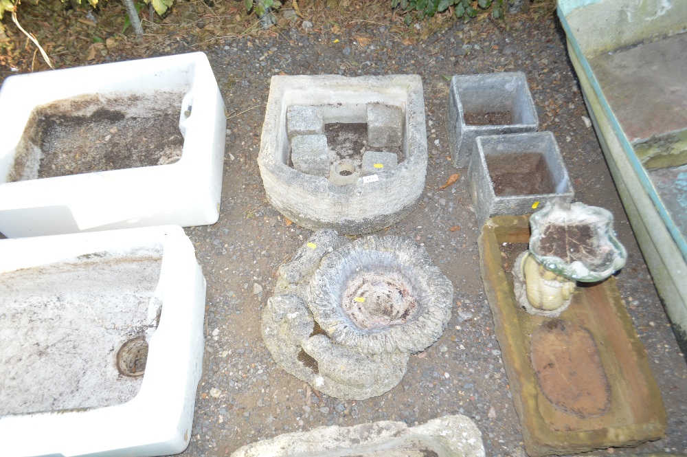 Two faux concrete planters; a concrete oblong plan