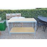 A two tier metal and wooden work bench