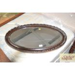 An oval bevel edged wall mirror