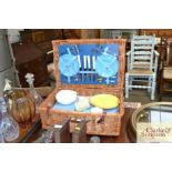 A wicker picnic hamper and contents