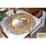 An ornate gilt framed circular mirror