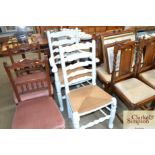 A painted rush seated ladder back elbow chair and