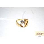 An 18ct gold ring set with a single diamond, s