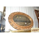 An oval gilt framed wall mirror