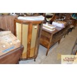 A 1930's demi lune walnut display cabinet