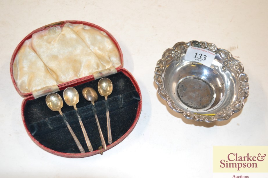 Four cased silver coffee spoons and a small white