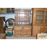 An antique stripped pine dresser.