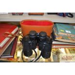 A pair of binoculars in fitted leather case